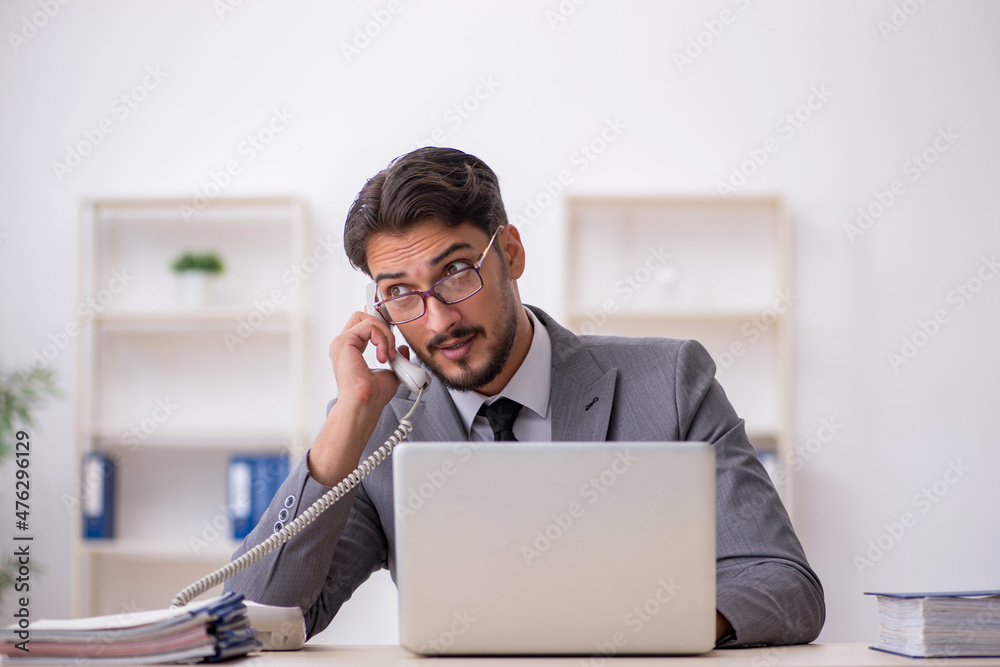Young male employee working in the office Young male employee working in the office