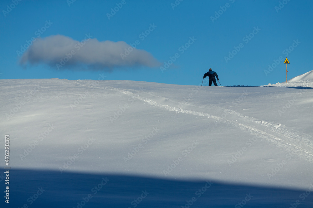 A person in the snow near cloud