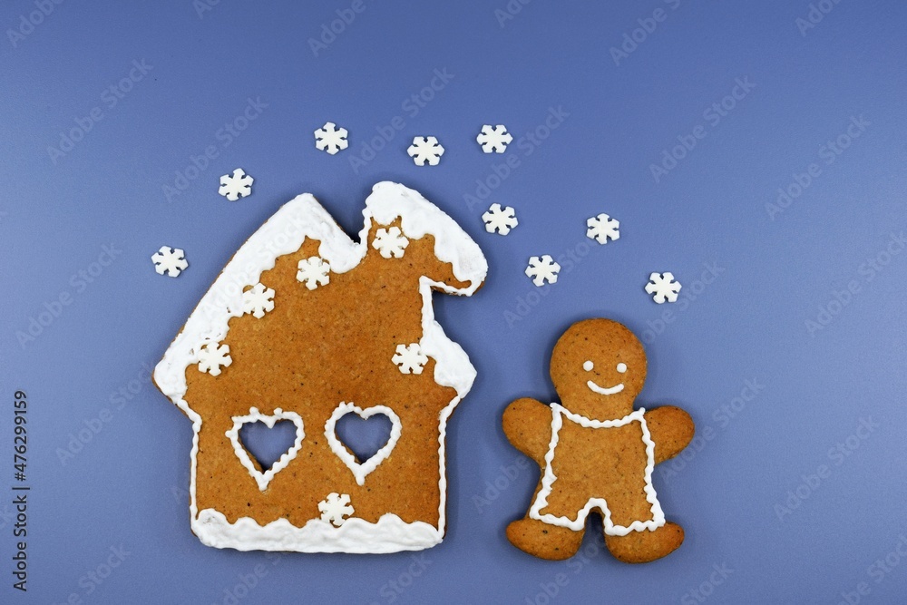 Romantic gingerbread house, smiling man and falling snowflakes. Christmas or winter time