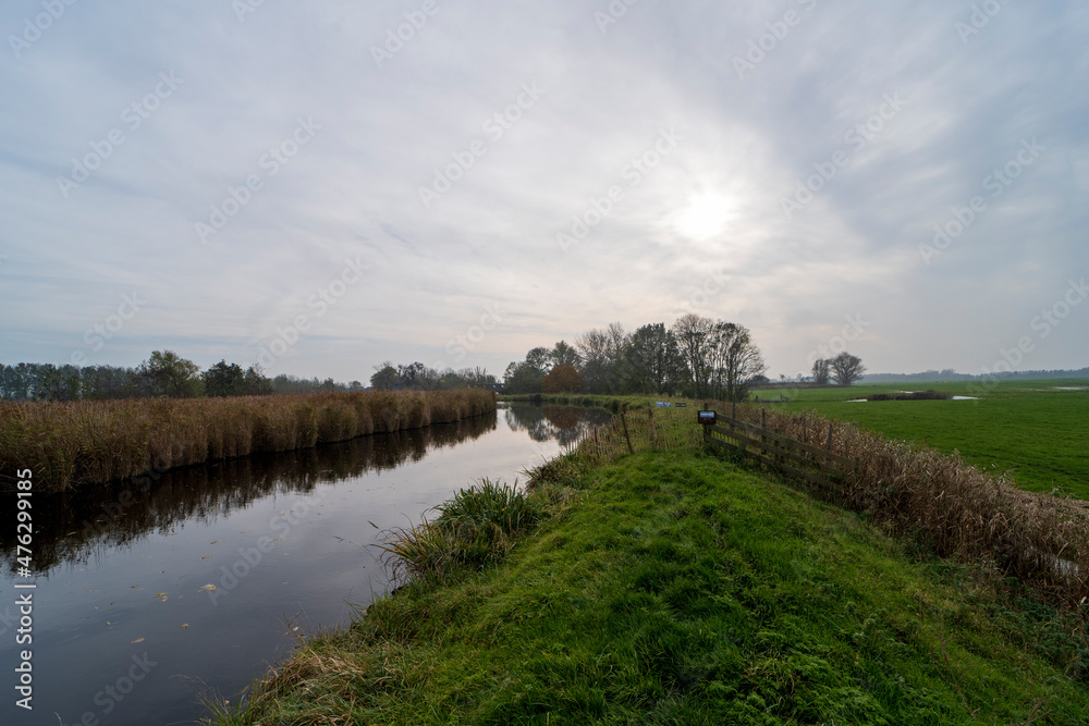 Fototapeta premium Autumn landscape photo of the Winkel river, The Netherlands