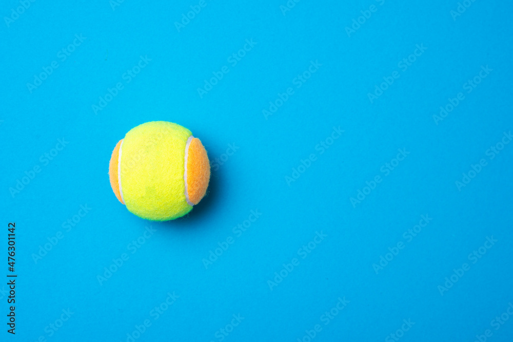 Beach tennis ball on blue background. Horizontal education and sport poster, greeting cards, headers, website.
