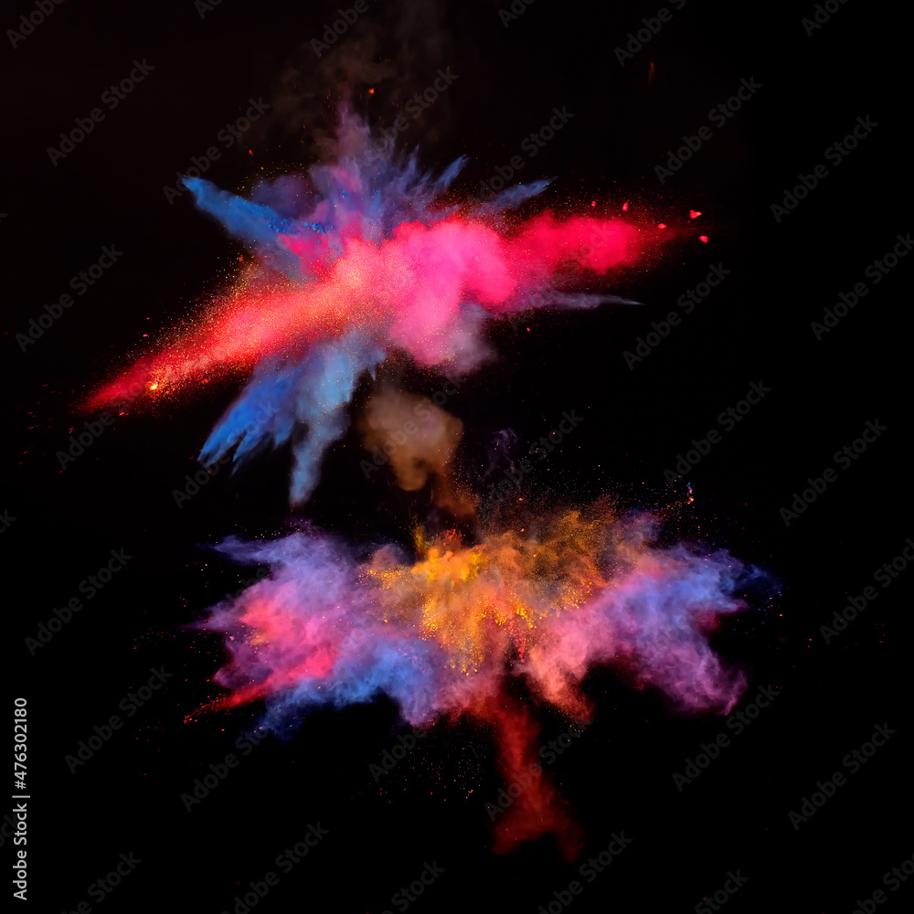 Bizarre forms of red and blue powder paint explode in front of a black background to give off fantastic multi colors and forms.
