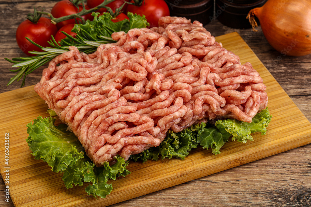 Raw pork minced meat over board Raw pork minced meat over board