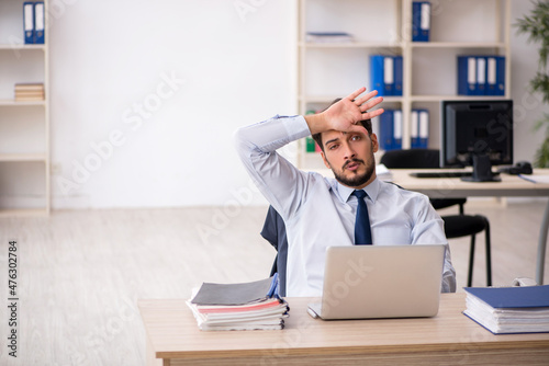 Young male employee working in the office