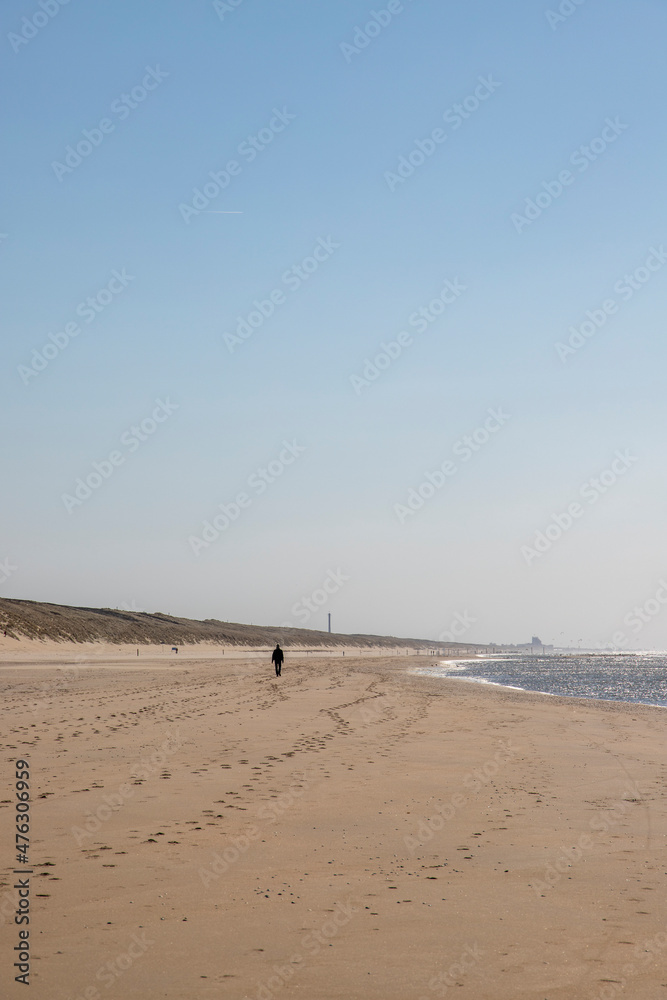 Single person walking at the beach Single person walking at the beach