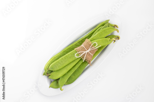 Flat Long Green Vegetable Runner Beans Known As Jhar Sim, Falia, Keralan, Sem Ki Phali, Surti Papdi, Guar Ki Fali, Gawar Isolated On White Background. Used To Cook Curry Bhaji Sabji Or Hari Sabzi photo