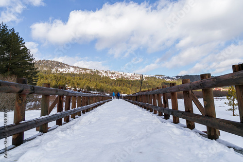 panoramic view of winter landscape. people walking on wooden walking path, with many snow and frozen trees. The Abant Lake Natural Park(Black Sea) Region.  © Birol