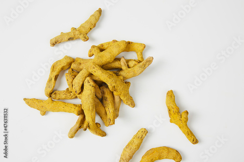 Dried turmeric root on white background