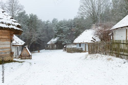 Misty winter morning. Traditional Polish village. Open-air museum in Tokarnia, Poland.
