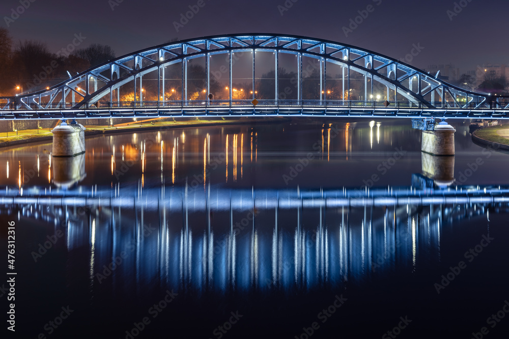 Pilsudski steel truss bridge over Vistula river in Krakow in the night