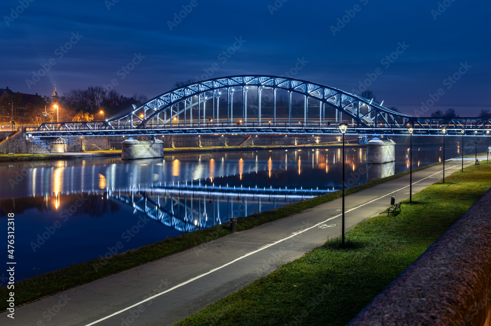 Pilsudski steel truss bridge over Vistula river in Krakow in the night