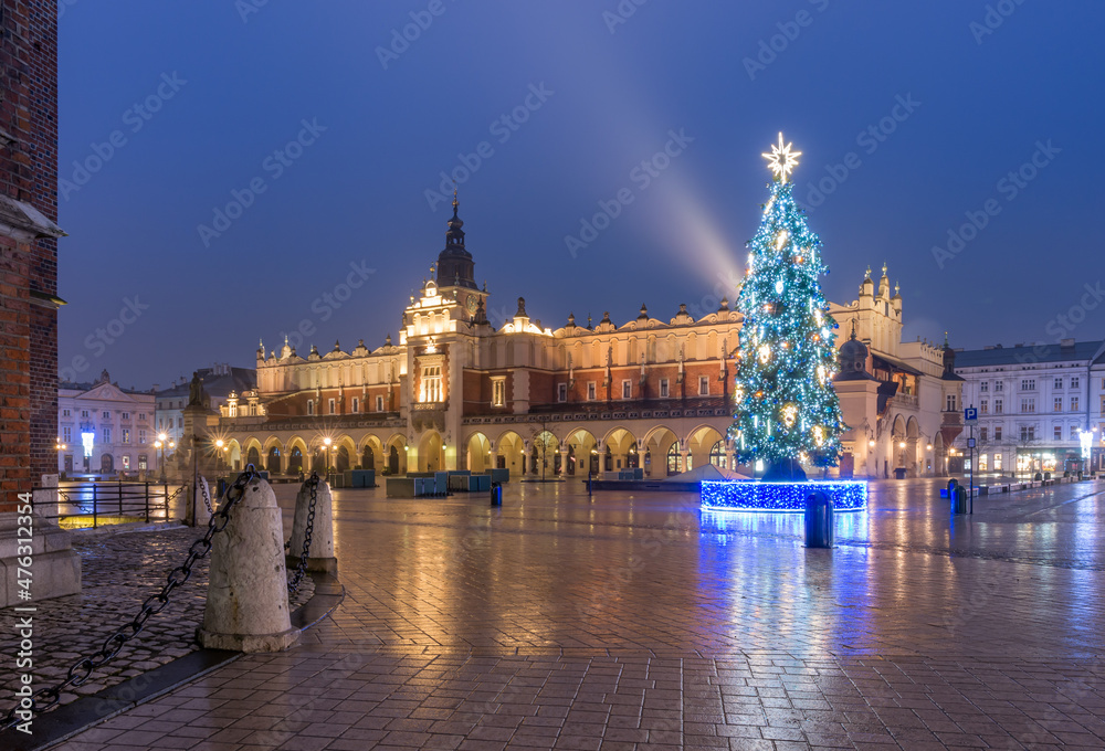 Cloth-hall (Sukiennice) in Krakow and Christmas tree on winter morning, main square.