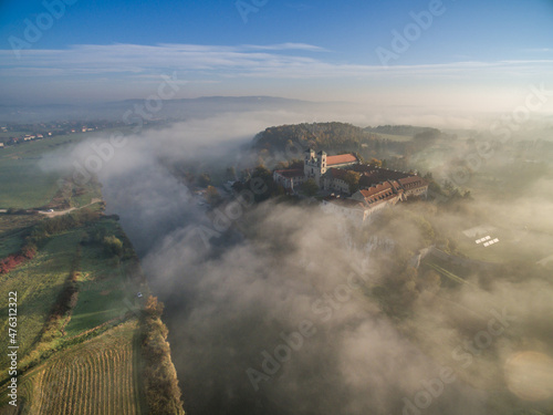 Aerial view of Tyniec abbey in the morning mists, beautiful sunrise, Krakow, Poland