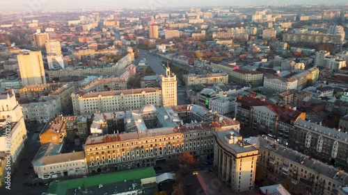 Sunny city aerial flight above autumn Podil district, downtown city streets rooftop in Kharkiv, Ukraine photo
