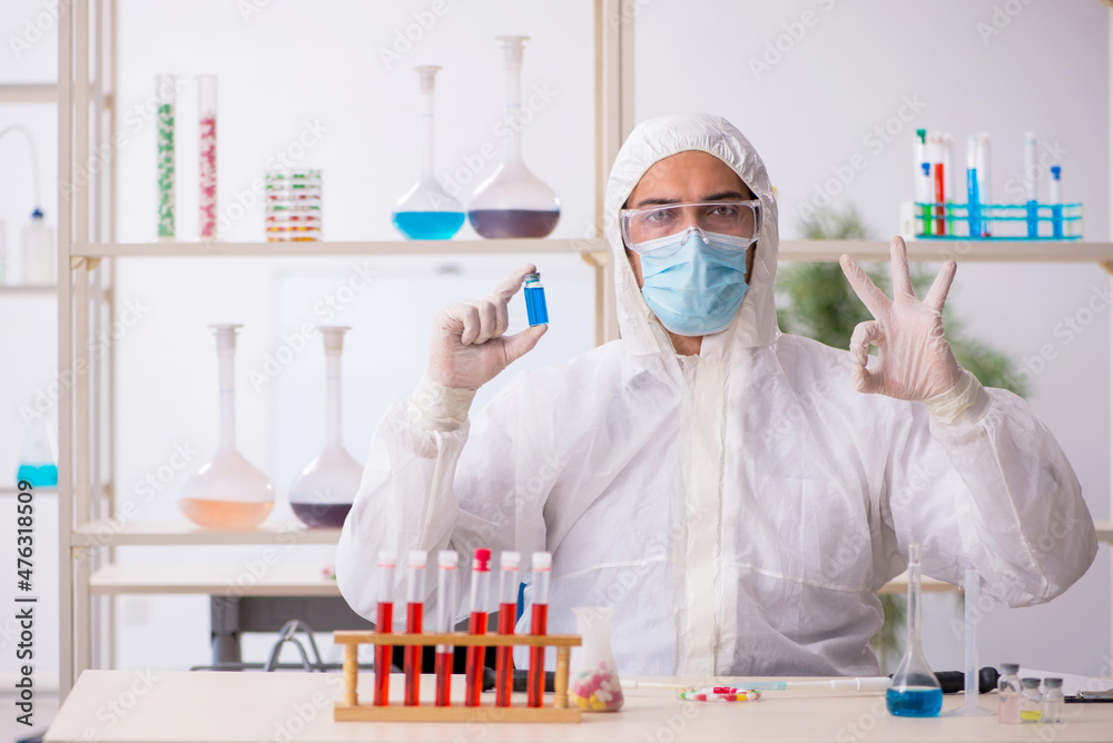 Young male chemist in drugs syntesis concept Young male chemist in drugs syntesis concept