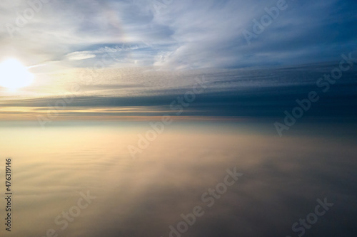 Wallpaper Mural Aerial view of vibrant yellow sunrise over white dense clouds with blue sky overhead. Torontodigital.ca