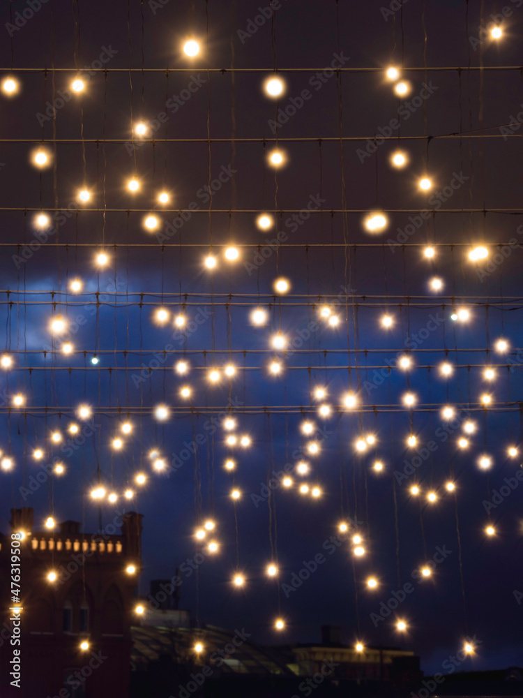 Streets of Moscow, decorated with light bulbs and lanterns on wired for New Year and Christmas celebration. Russia.