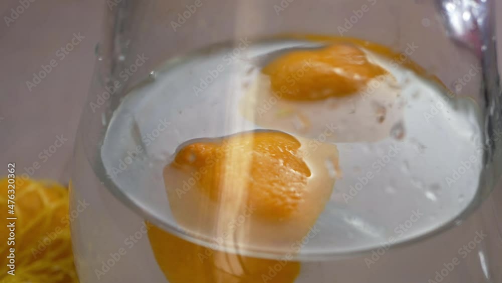 Fresh lemons floating in a pitcher of water