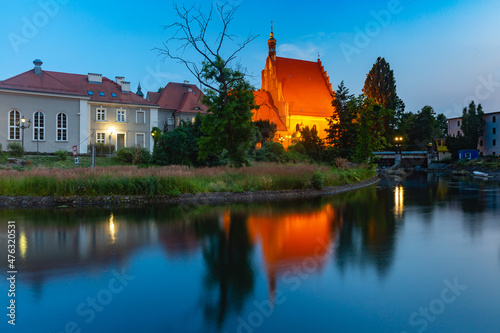 Panorama of Brick Gothic Bydgoszcz Cathedral with reflection in Brda River at night, Bydgoszcz, Poland