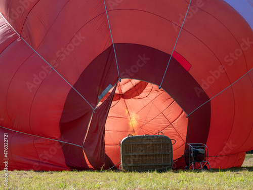 Fototapeta Red hot air balloon inflation