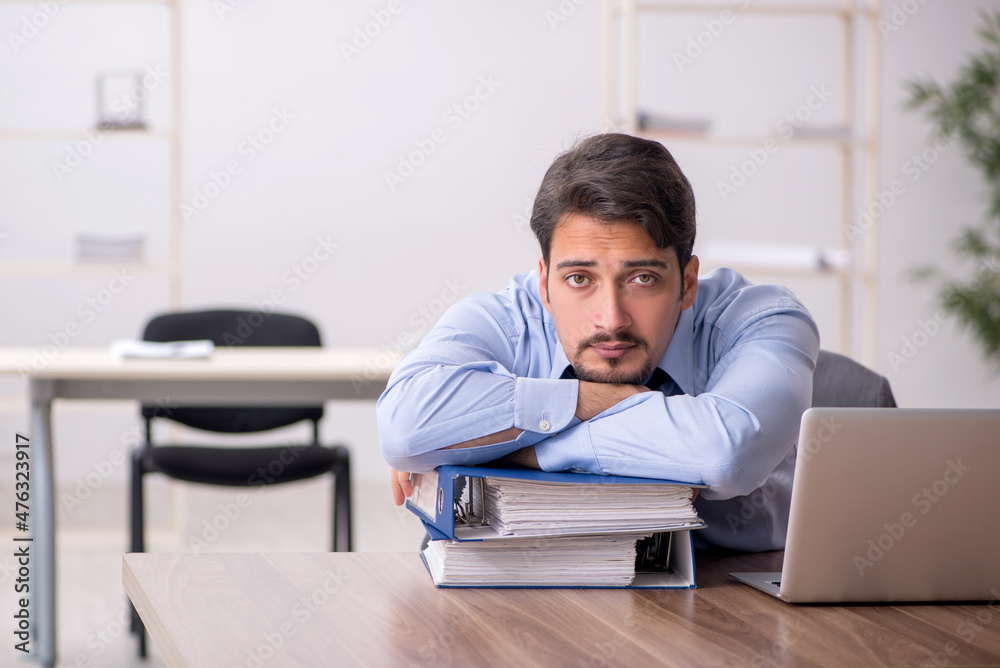 Young male employee working in the office Young male employee working in the office