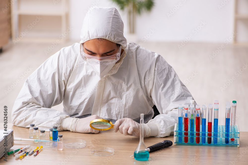 Young male chemist working at the lab during pandemic Young male chemist working at the lab during pandemic