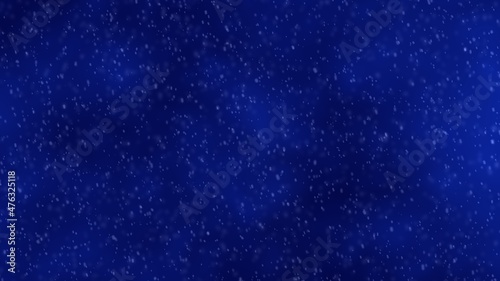 Beautiful snow falling on an abstract blue sky background. Winter holiday concept.