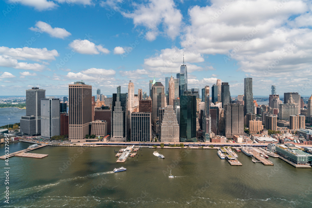 Obraz premium Aerial panoramic city view of Lower Manhattan area over East River, New York City, USA. Bird's eye view from helicopter of metropolis cityscape. A vibrant business neighborhood.