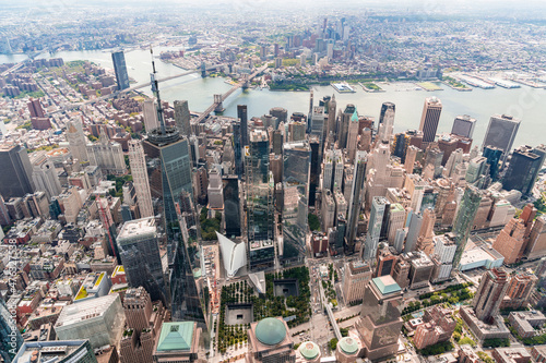 Aerial city view on Lower Manhattan area. Brooklyn and Manhattan bridges over East River, New York City, USA. Bird's eye view from helicopter of metropolis cityscape. A vibrant business neighborhood.