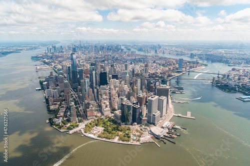 Aerial panoramic city view on Lower Manhattan district and financial Downtown  New York City  USA. Bird s eye view from helicopter. A vibrant business neighborhood. Hudson River and East River.