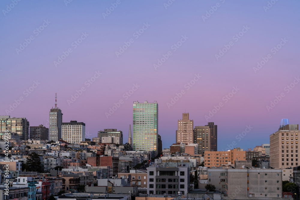 Panoramic cityscape view of San Francisco Nob hill area, which is known as a center of San Francisco upper class residential neighborhoods at purple sunset, midtown, California, United States.