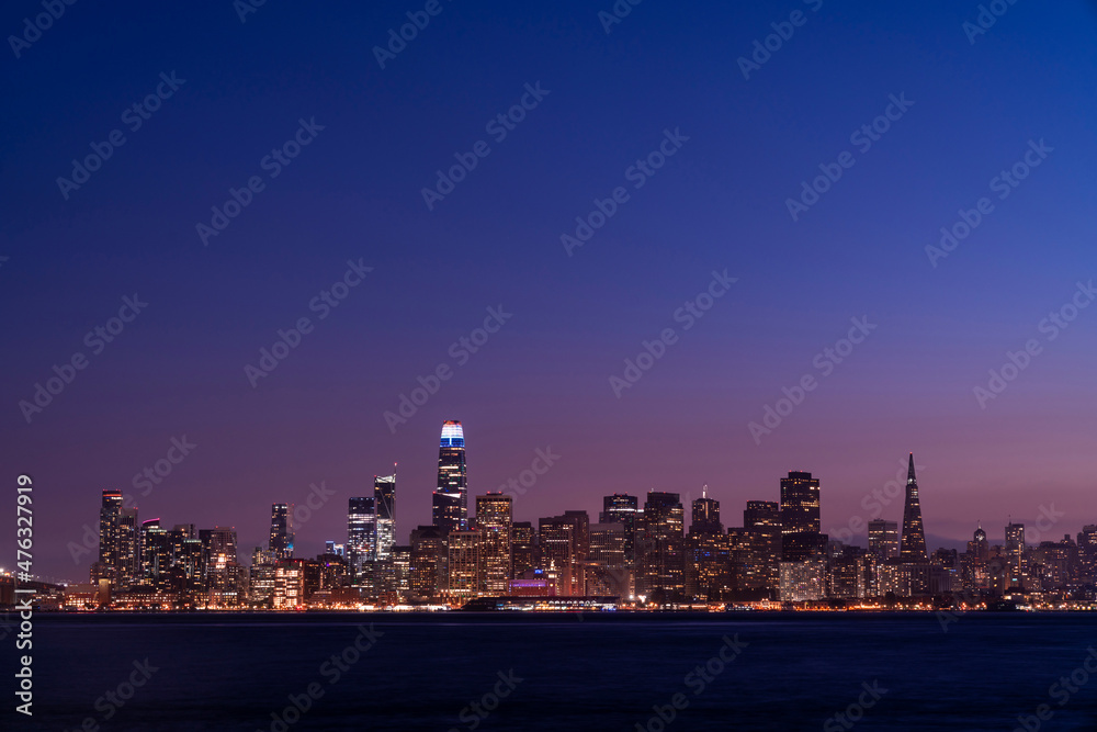A picturesque skyline of San Francisco Panorama at night time from Treasure Island, California, United States. Panoramic view of cityscape, Illuminated night city A picturesque skyline of San Francisco Panorama at night time from Treasure Island, California, United States. Panoramic view of cityscape, Illuminated night city