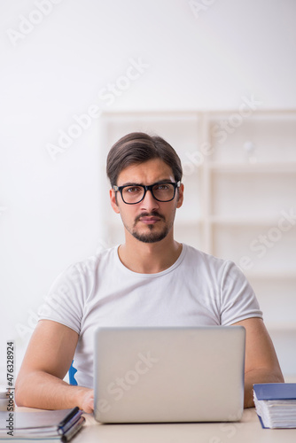 Young male employee freelancer sitting in the office