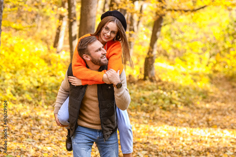Young man and his girlfriend having fun in autumn park Young man and his girlfriend having fun in autumn park