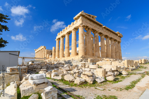 View of the Parthenon on Acropolis Hill in Athens, Greece with a deep blue sky behind.