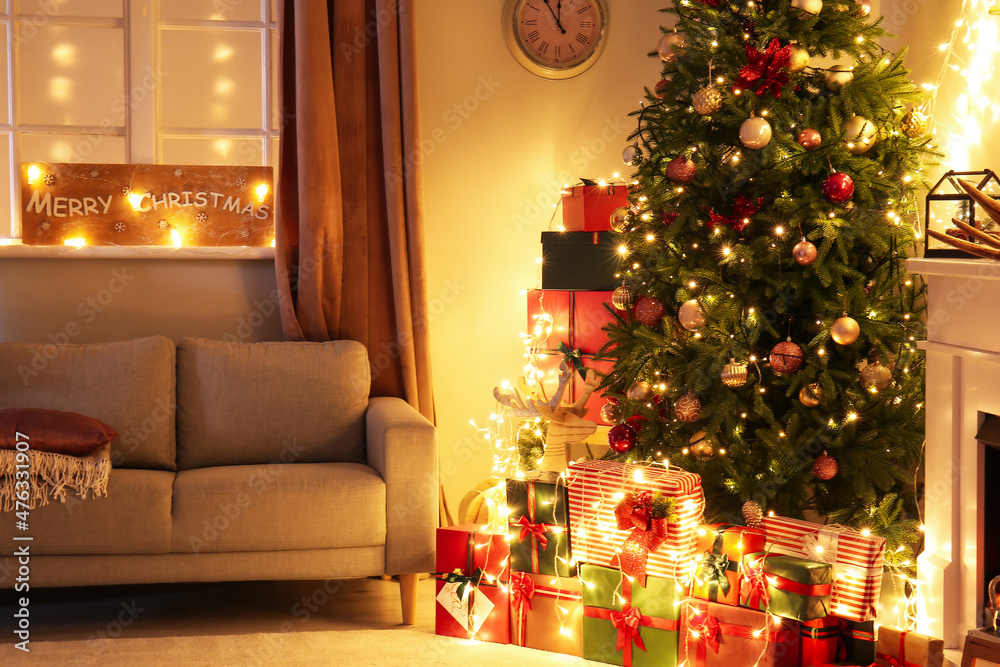 Stylish interior of living room with beautiful Christmas tree at night Stylish interior of living room with beautiful Christmas tree at night