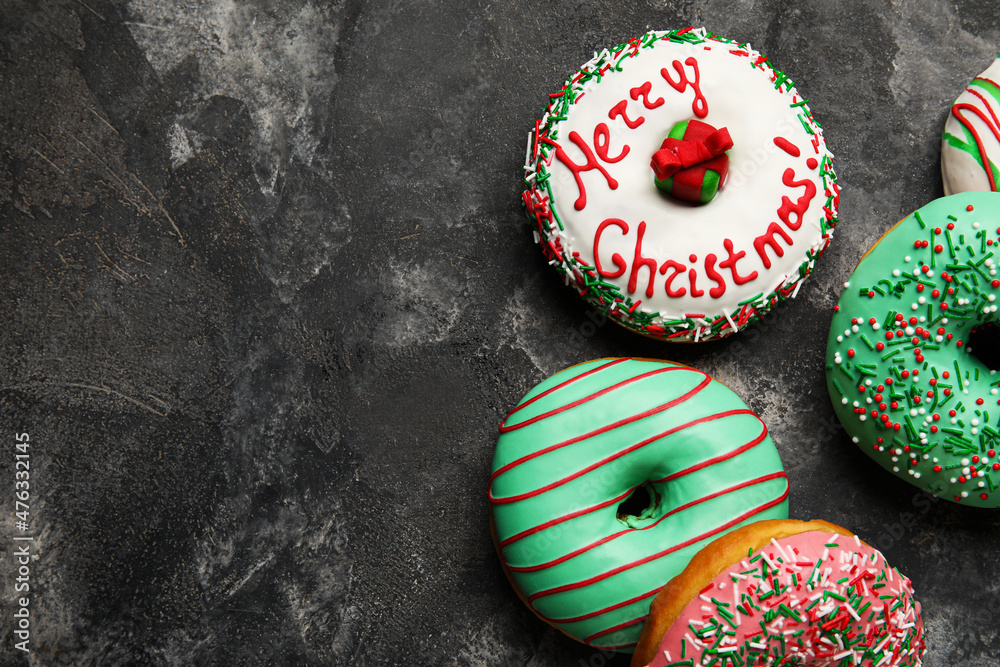 Tasty Christmas donuts on grey background