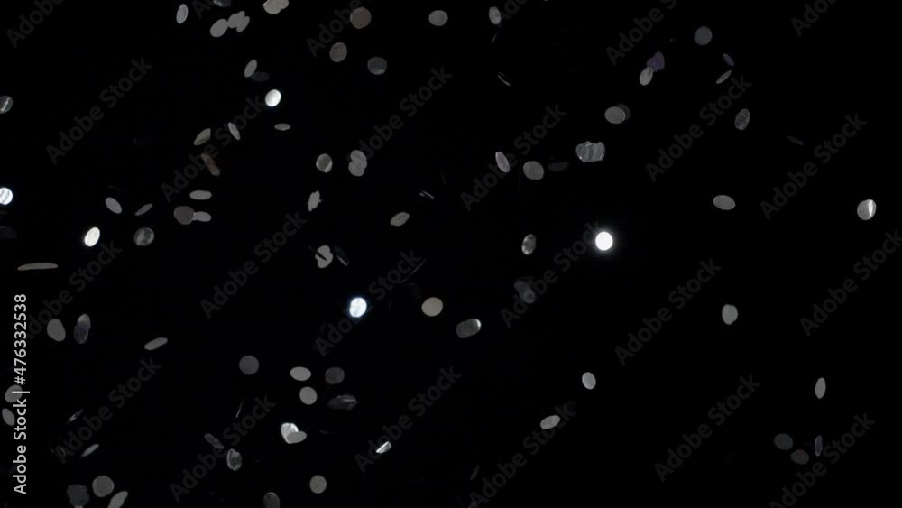 Many falling confetti on black background Many falling confetti on black background