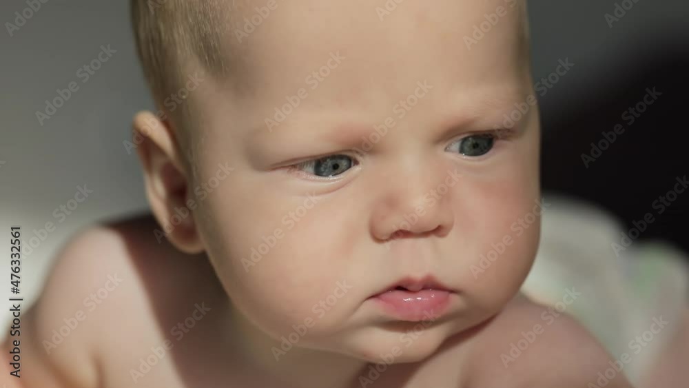 Portrait of infant baby boy, face shows tongue Portrait of infant baby boy, face shows tongue