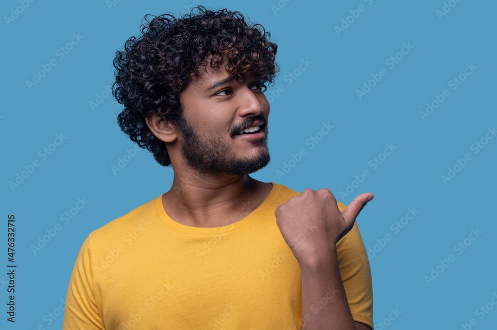 Male pointing sideways using the first digit of his hand Male pointing sideways using the first digit of his hand