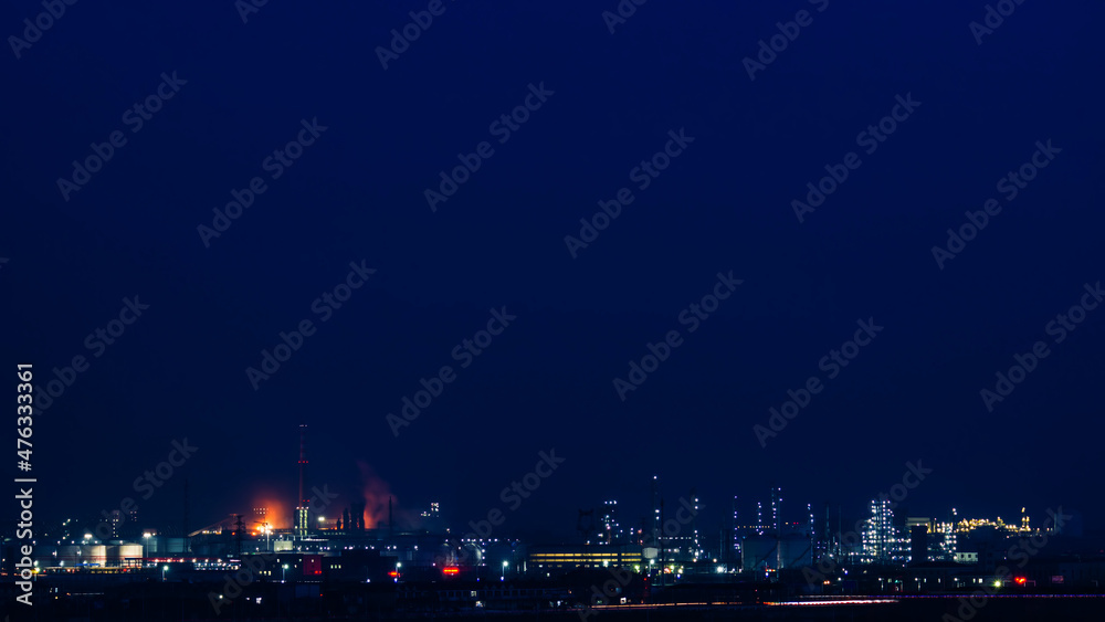 The brightly lit petrochemical plant.