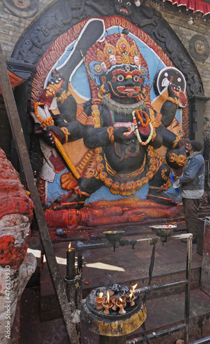 Kathmandu, Nepal: Hindu shrine of Kala Bhairab (Black Bhairab) standing on a demon in Kathmandu's Durbar Square photo