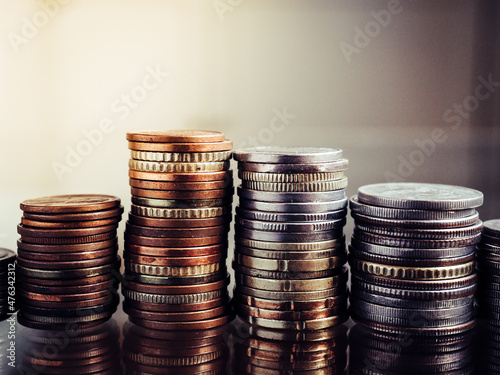 Close up shot of stacked coins with different color, copper, silver and mixed. Edited with dark tone with high contrast