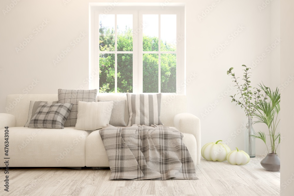 Fototapeta premium Minimalist living room in white color with sofa and summer landscape in window. Scandinavian interior design. 3D illustration