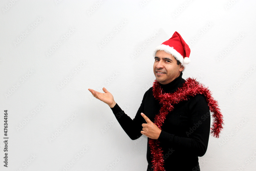 Dark Latino adult man with Christmas hat and garland excited and happy for the arrival of December and celebrating Christmas and New Years
Dark Latino adult man with Christmas hat and garland excited and happy for the arrival of December and celebrating Christmas and New Years