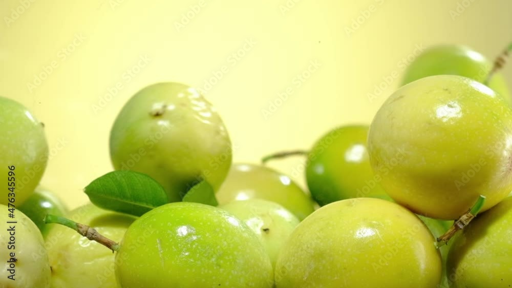 Slowmotion of passion fruit falling down with a yellow background Slowmotion of passion fruit falling down with a yellow background