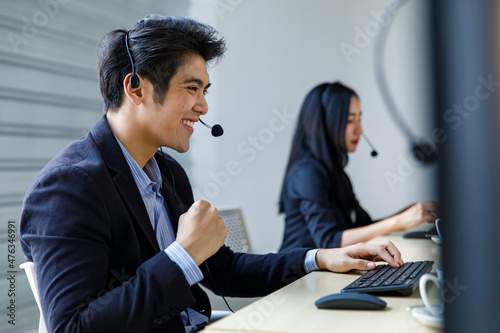 Bilde på lerret Asian happy male corporate receptionist operator service support employee staff