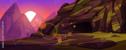 Mountains with entrance to dark cave at sunset. Vector cartoon illustration of summer landscape with rocks, deep stone cavern or mine, green grass and sun at evening
