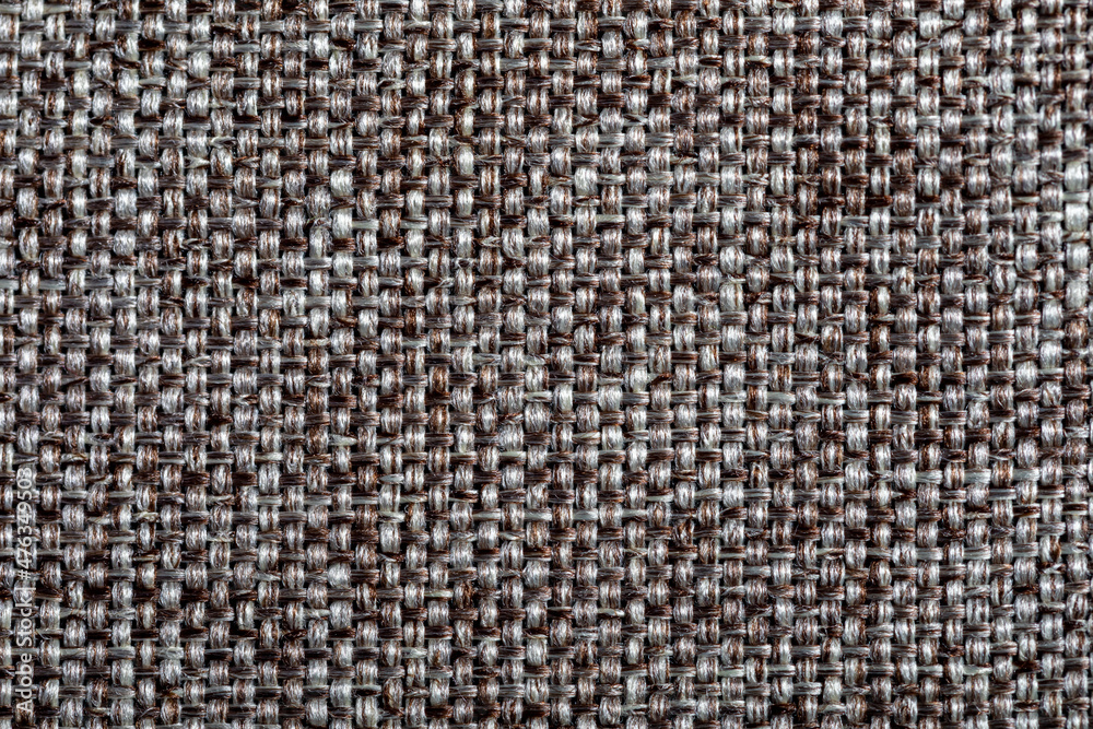 Brown fabric texture. Furniture upholstery textiles. Embossed pattern. Woven fibers. The material is soft touch. Minimalism concept. High detail macro photography for backgrounds or wallpapers. Brown fabric texture. Furniture upholstery textiles. Embossed pattern. Woven fibers. The material is soft touch. Minimalism concept. High detail macro photography for backgrounds or wallpapers.