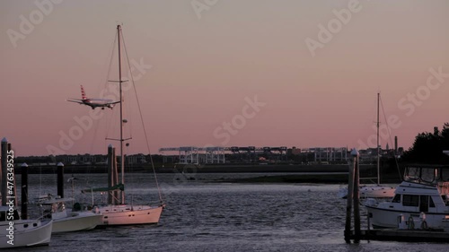 plane lands at boston logan airport viewed from yacht club
